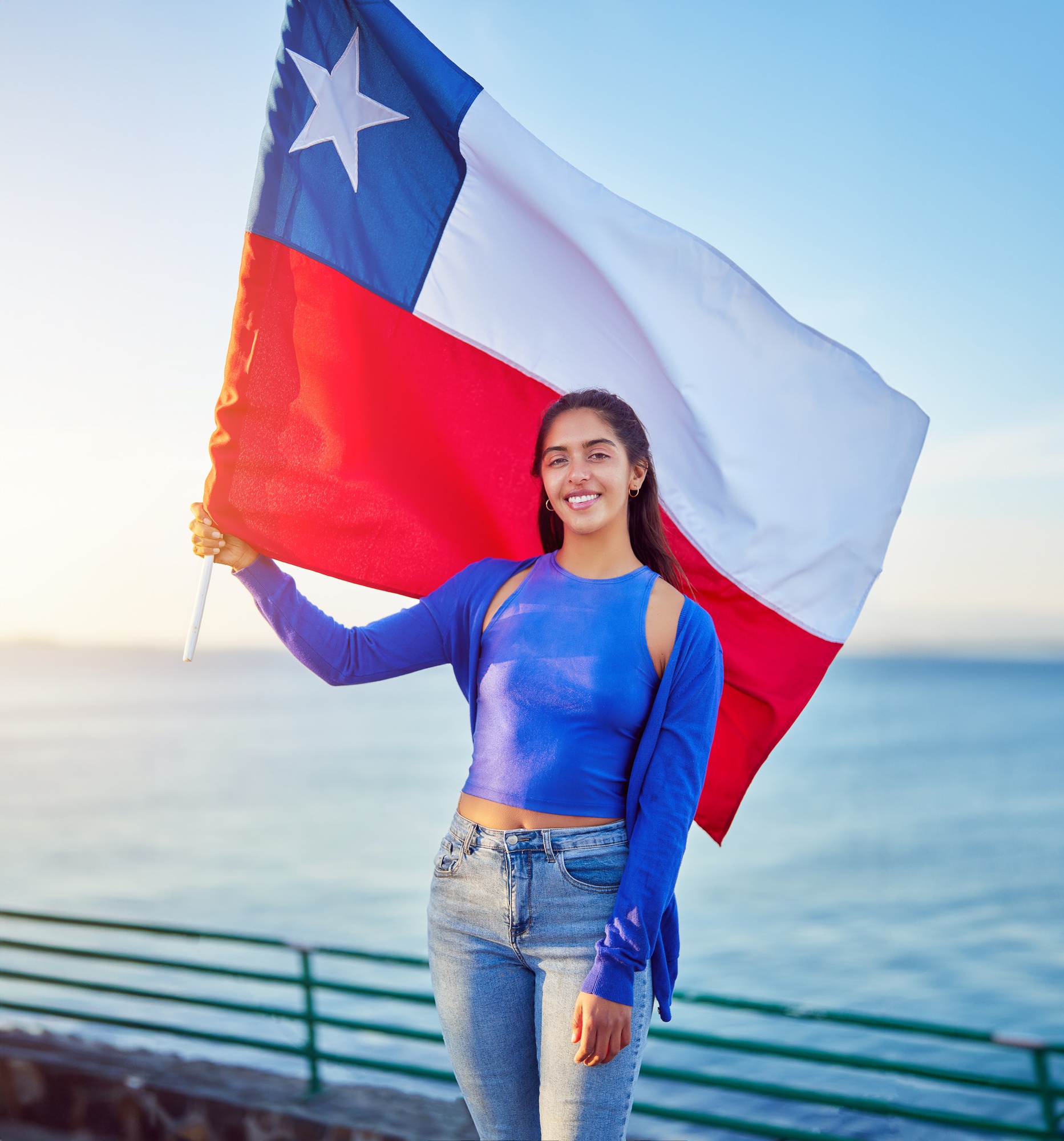 latin woman holding a flag of chile outdoors